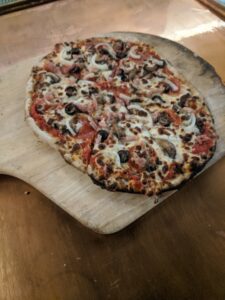 sausage pizza on peel