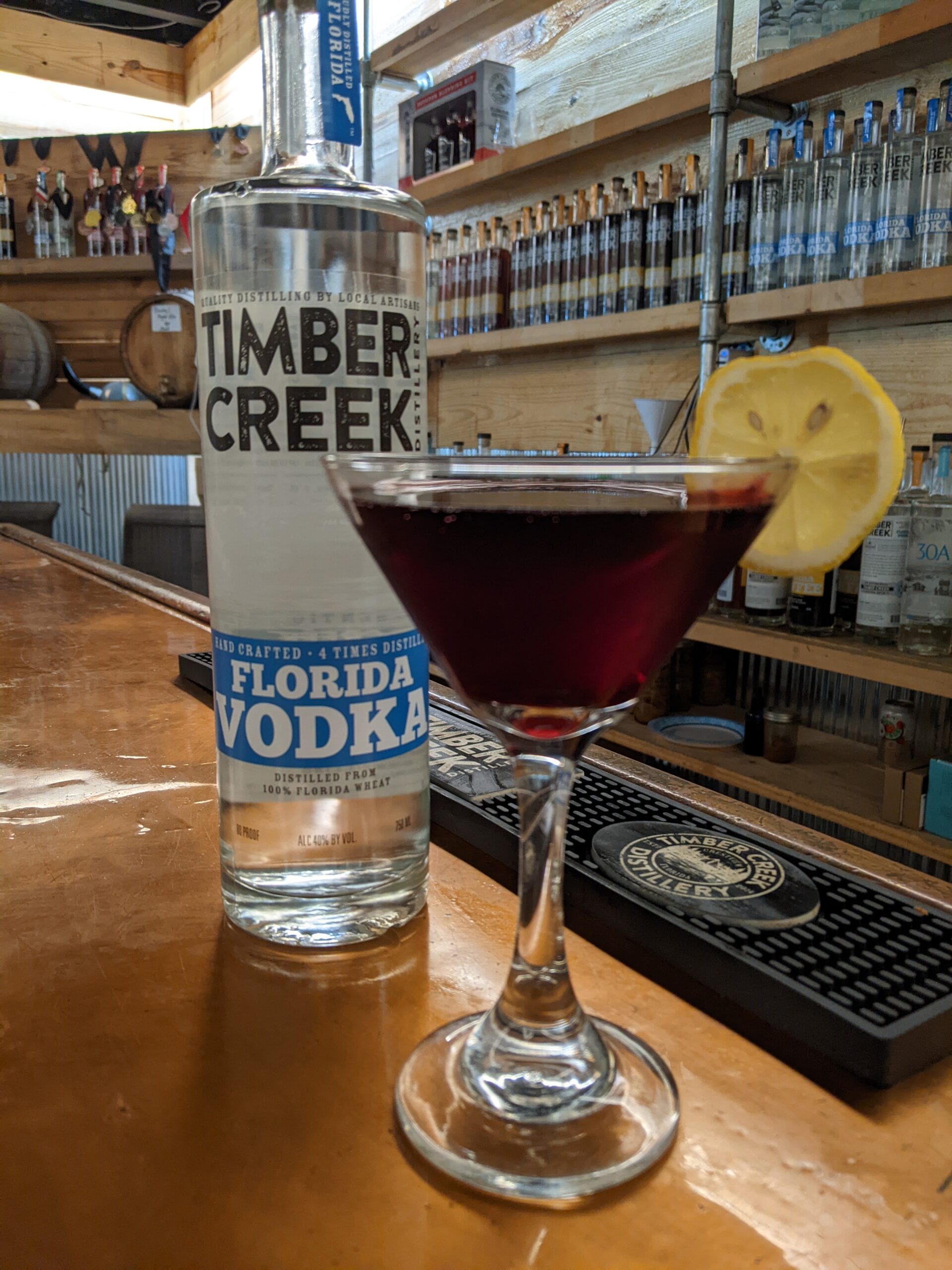 A blueberry shrub sits in a cocktail glass inside the Timber Creek Distillery tasting room.