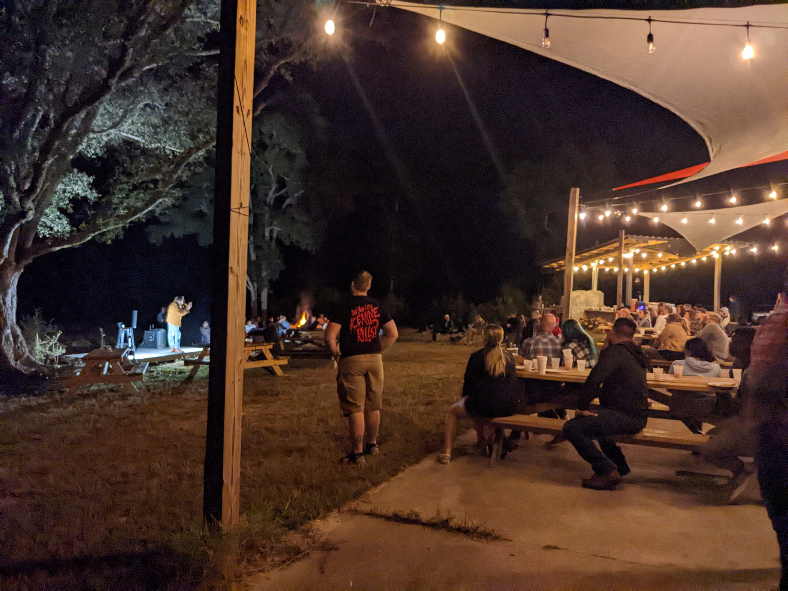 comedy show with cafe lights pizza oven in backgroud